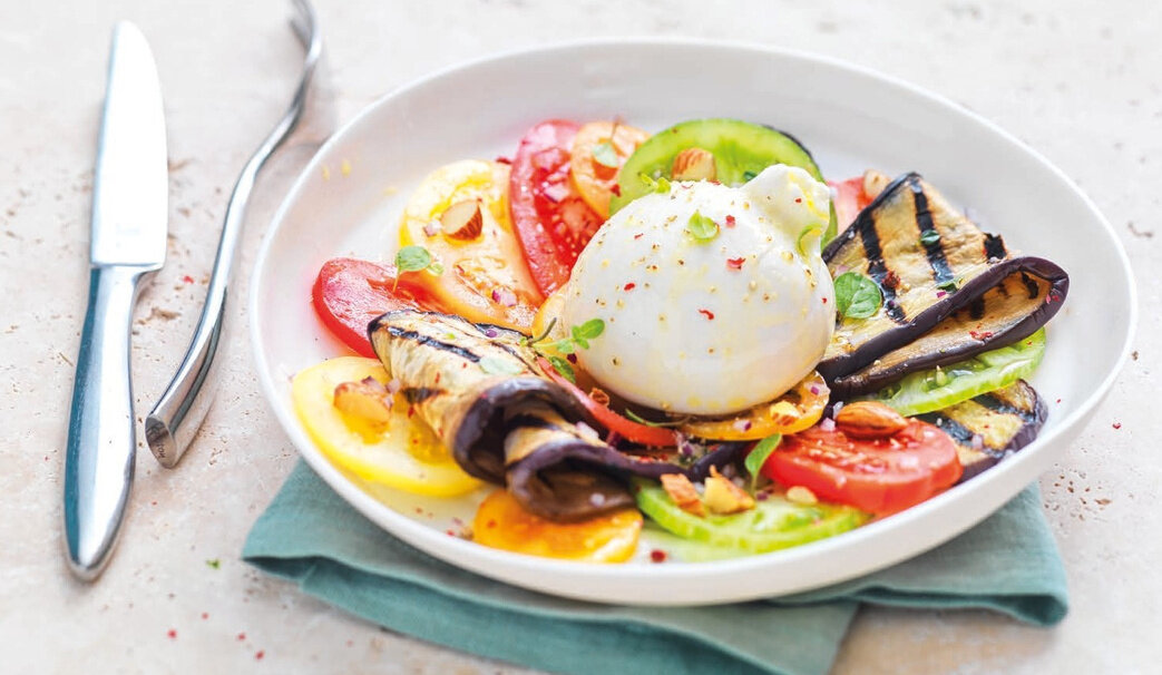 Burrata on a plate with fresh vegetables